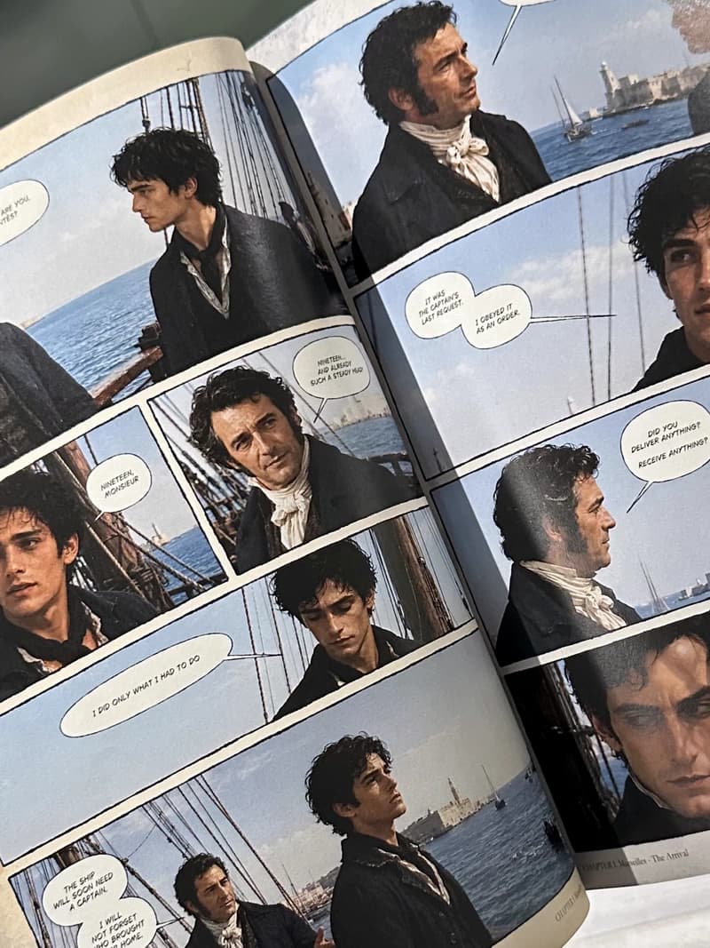 Open printed Volume I edition showing a full two-page comic spread
